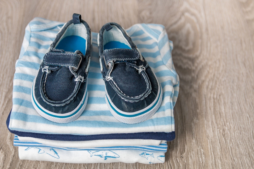 2folded-blue-and-white-bodysuit-with-shoes family infant pregnancy help adoption care foster