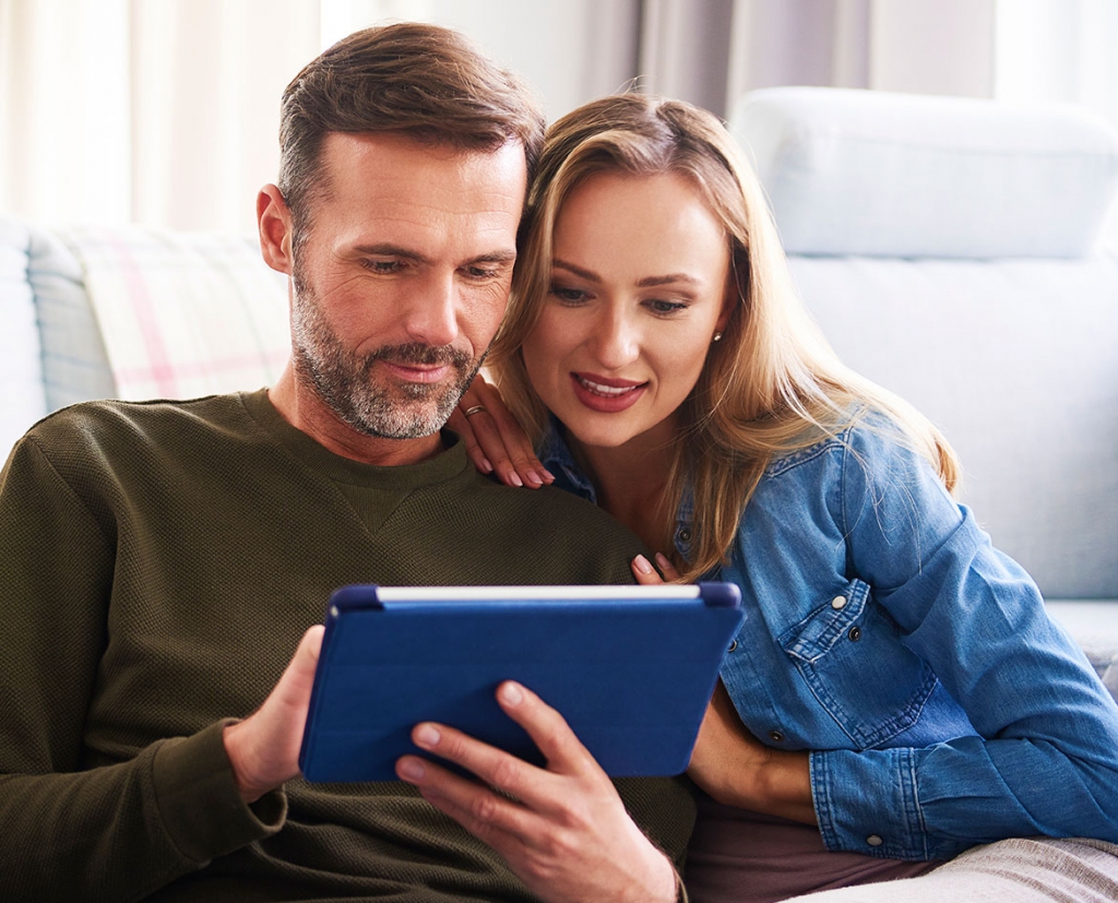 couple-using-a-tablet-in-living-room adoption family parent options